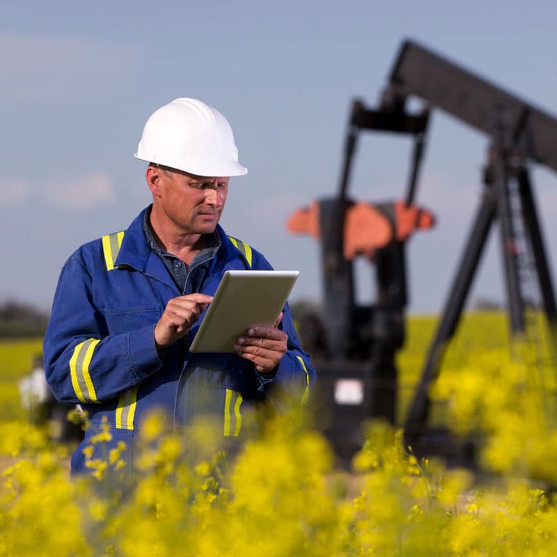 Oil and gas field worker accessing documents remotely.