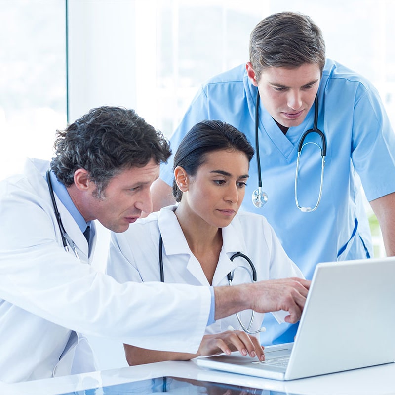 Healthcare workers collaborating on document and email management.