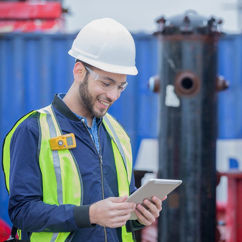 Energy and utility worker viewing communications on device.